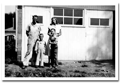 Elmer, Millie, Jon, and Fred. Probably 1949, in front of the workshop.